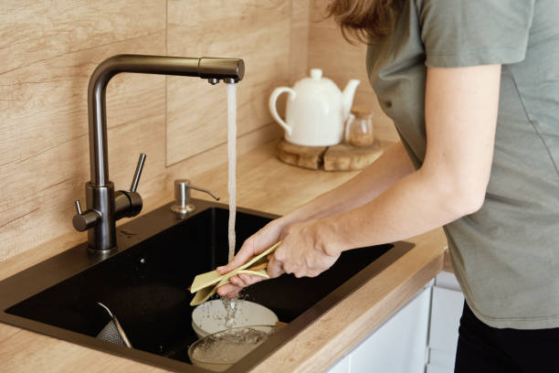 istock Woman waching dishes in kitchen sink 1399524940
