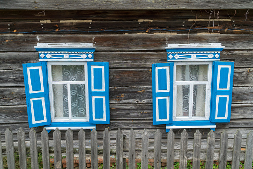 Carved wooden windows in old wooden houses in Oleshnia village, Chernihiv region, Ukraine. Ukrainian culture heritage