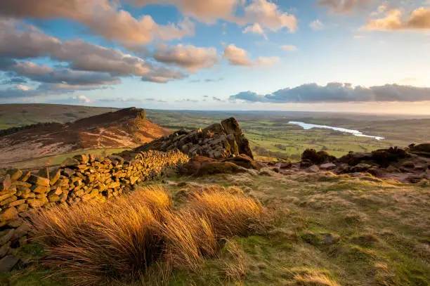 Wide angle view of warm sunset light on The Roaches in The Peak District National Park, Staffordshire, England, UK