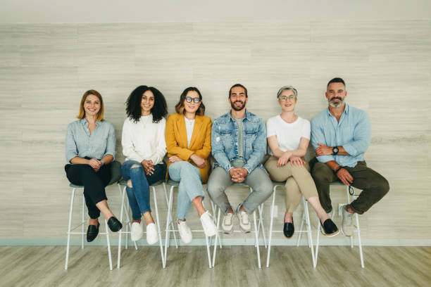 istock Cheerful job applicants sitting together in a row 1399531793