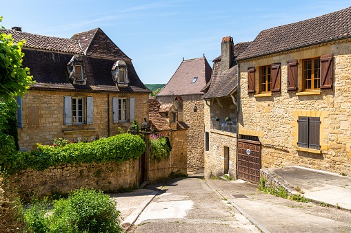 Saint-Cyprien, France - 11 May, 2022: view of the historic village center of Saint-Cyprien with traditional brown stone houses