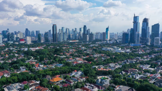 istock Dramatic sky over Jakarta downtown skyline where modern skyscrapers contrasts with poor residential district in Indonesia capital city 1399532115