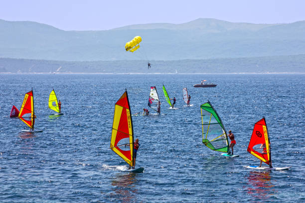 Many young people are enjoying windsurfing on a fine, windy Sunday afternoon at Miura Beach, Miura City, Kanagawa Prefecture. Miura Beach is located at the entrance to Tokyo Bay from the Pacific Ocean.