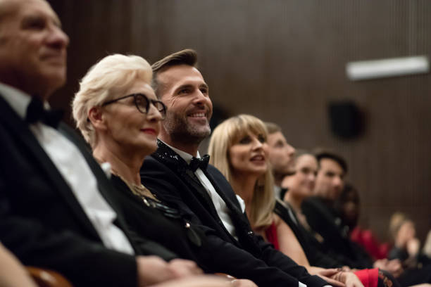istock Smiling spectators sitting in the theater 1399537240