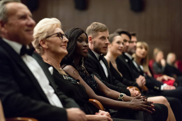 istock Smiling spectators sitting in the theater 1399537330