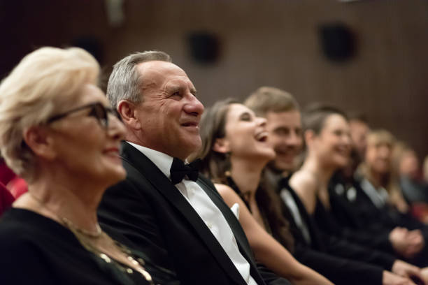 istock Smiling spectators sitting in the theater 1399537498