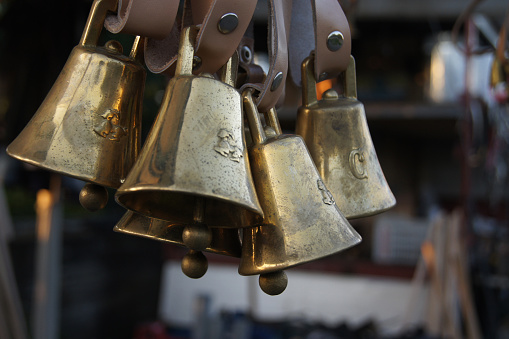 Cow bells hanging in an market stall at the animal fair in Giardini Naxos, Sicily