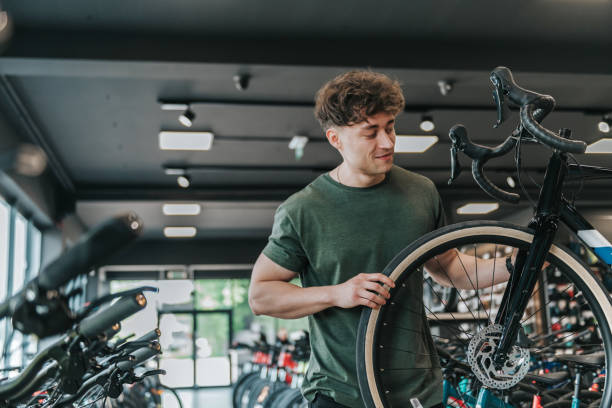 istock young man checking out at new bicycle in bikeshop 1399539598