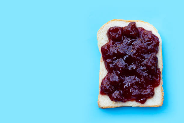 istock Bread with strawberry jam on blue background 1399539674
