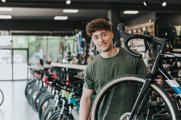 portrait of young owner in his bike shop stock photo