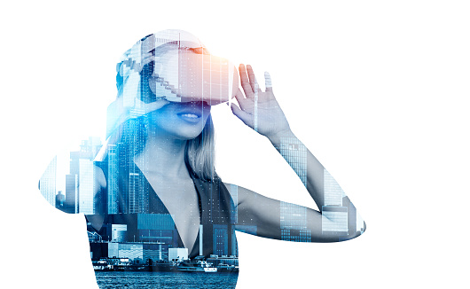 Businesswoman silhouette in vr headset, skyscrapers toned image. Circuit of connection and cyberspace. Concept of alternate reality and future technology