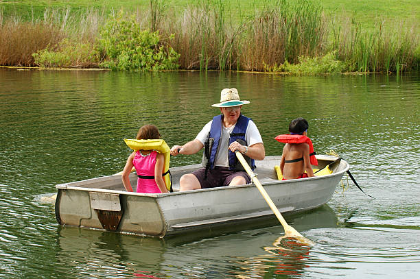 istock Grandfather with kids in rowboat 139954116