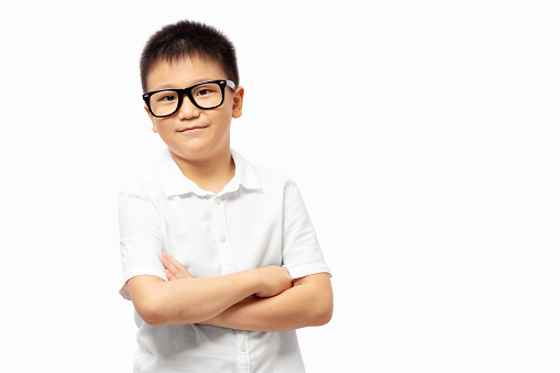 Smart kid cross arm, wearing eyeglasses and white shirt isolated on white background