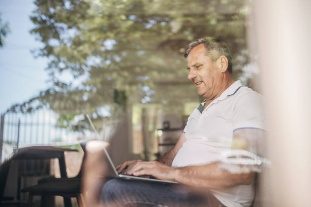istock A man with gray hair uses a laptop 1399541579