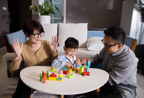 istock Mom, dad and baby boy playing with blocks 1399542463