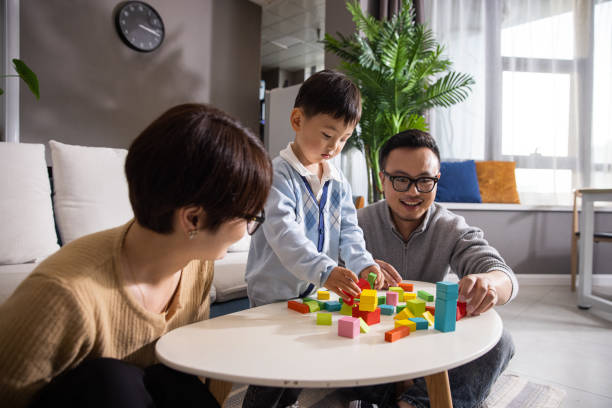 istock Mom, dad and baby boy playing with blocks 1399542474