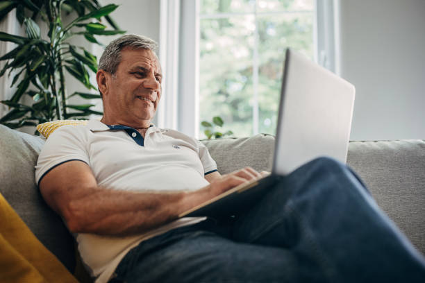 istock An older man uses a laptop, online communication 1399542510