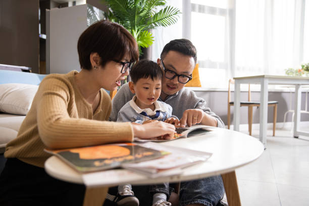 istock Mom, dad and child reading picture book 1399542558
