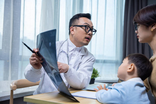 istock Doctor shows x-ray to concerned parent 1399542734