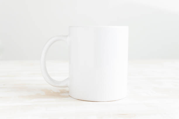 istock White ceramic cup on the table front view. Mug mockup, empty template for drawing design, place for text and logo. 1399547906