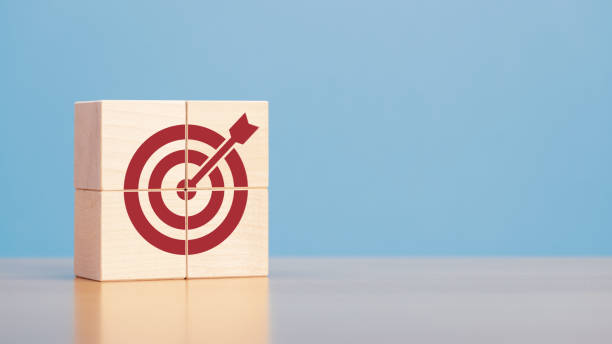 istock Wooden blocks with red target icon on wooden table blue background copy space. 1399549496