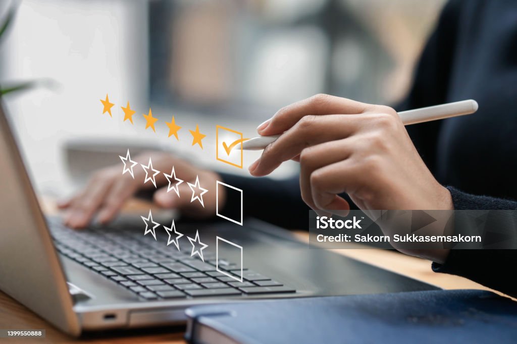 Businessman typing on a computer keyboard, customer service satisfaction survey concept. Business people choose the highest satisfaction rating and give 5 stars. Satisfaction, rating, rating. Rating Stock Photo