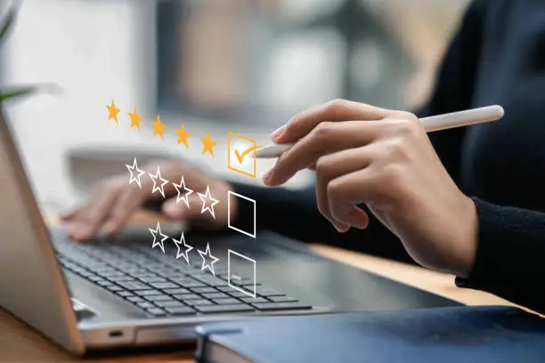 Photo of Businessman typing on a computer keyboard, customer service satisfaction survey concept. Business people choose the highest satisfaction rating and give 5 stars. Satisfaction, rating, rating.