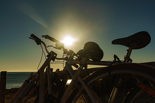 Bicycle outdoor on beach, morning time, sunup. Holidays, sport and recreation.