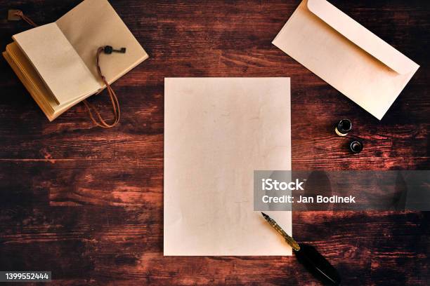 Flatlay With A Letter On A Wooden Table Stock Photo - Download Image Now - High Angle View, Ink Well, Backgrounds