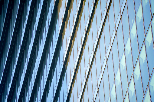 Closeup modern glass office building, abstract background with copy space, full frame horizontal composition