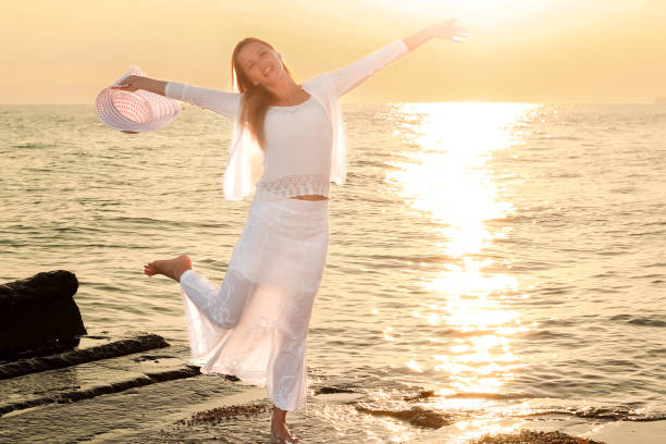istock Young women enjoying her vacation at the beach 1399554633