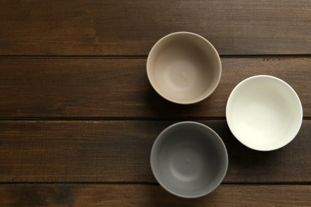 istock Stylish empty ceramic bowls on wooden table, flat lay and space for text. Cooking utensils 1399555656
