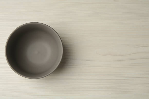 istock Stylish empty ceramic bowl on white wooden table, top view and space for text. Cooking utensil 1399556079