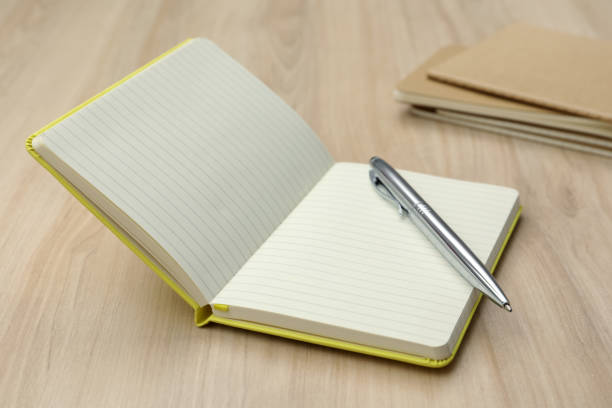 istock Open notebook and pen on wooden table. Personal planning 1399556146
