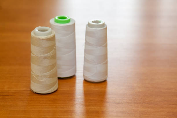 istock Reels with white threads for a sewing machine in atelier 1399556191
