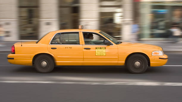 Yellow cab in the action stock photo