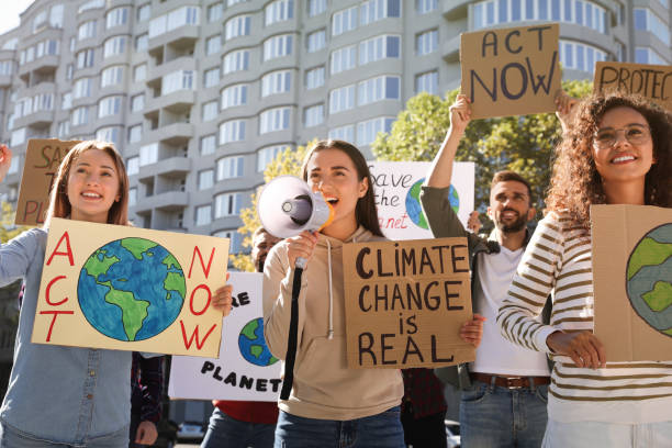 istock Group of people with posters protesting against climate change outdoors 1399558608