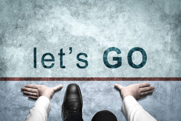 Businessman ready to start on starting line with inscription Let's Go. businessman ready to start. Top view of man on Start line, Business Challenge or do new. Let's Go to Moving Forward. Let's Go empresario listo para comenzar en la línea de salida con la inscripción let's go. hombre listo para empezar. forma de negocios exitosa. hombre de negocios prepárate para comenzar en la carretera. comience la línea let's go. inicio de negocio
