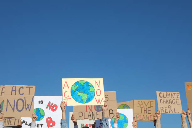 istock Group of people with posters protesting against climate change outdoors, closeup 1399558909
