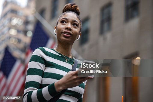istock Close up of a young American woman using phone 1399558912