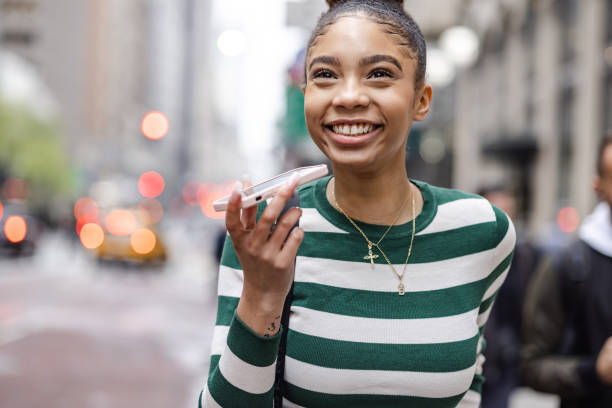 istock Cute young woman smiling while talking on the phone 1399559344