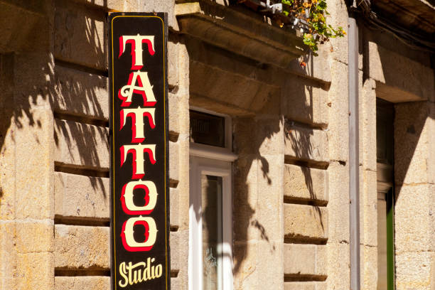Tattoo studio sign in old town, stone facades.