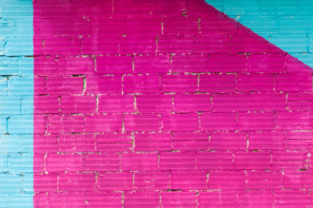 istock Brick wall painted pink and blue, background full frame. 1399561664