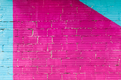 Brick wall painted pink and blue, backgrounds full frame image, copy space available.