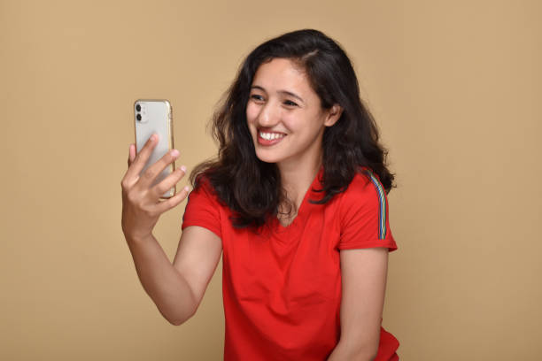 istock Young woman talking on video call using smartphone 1399565462