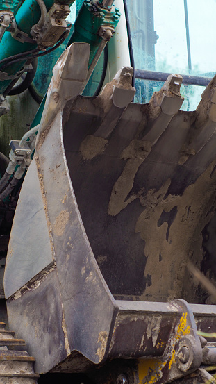 Close-up view of various parts composing a mechanical excavator, used on a limestone extraction site