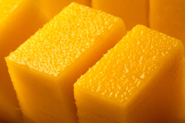 istock Juicy ripe yellow Thai mango on a white background. Hard light and shadow from a palm tree. 1399570925