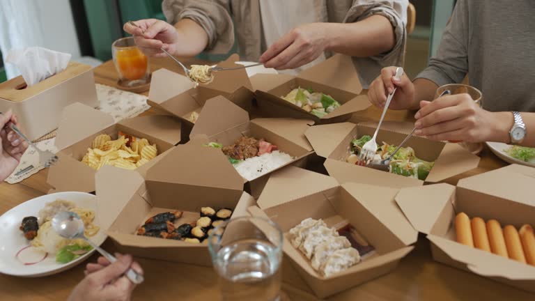 Asian families enjoy eating the food they ordered.