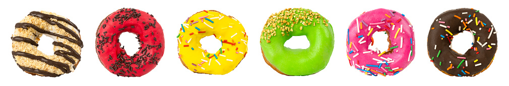 set of different donuts with colorful sprinkles isolated on white.