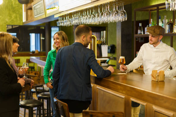 istock Clients and bartender in an elegant bar 1399572813